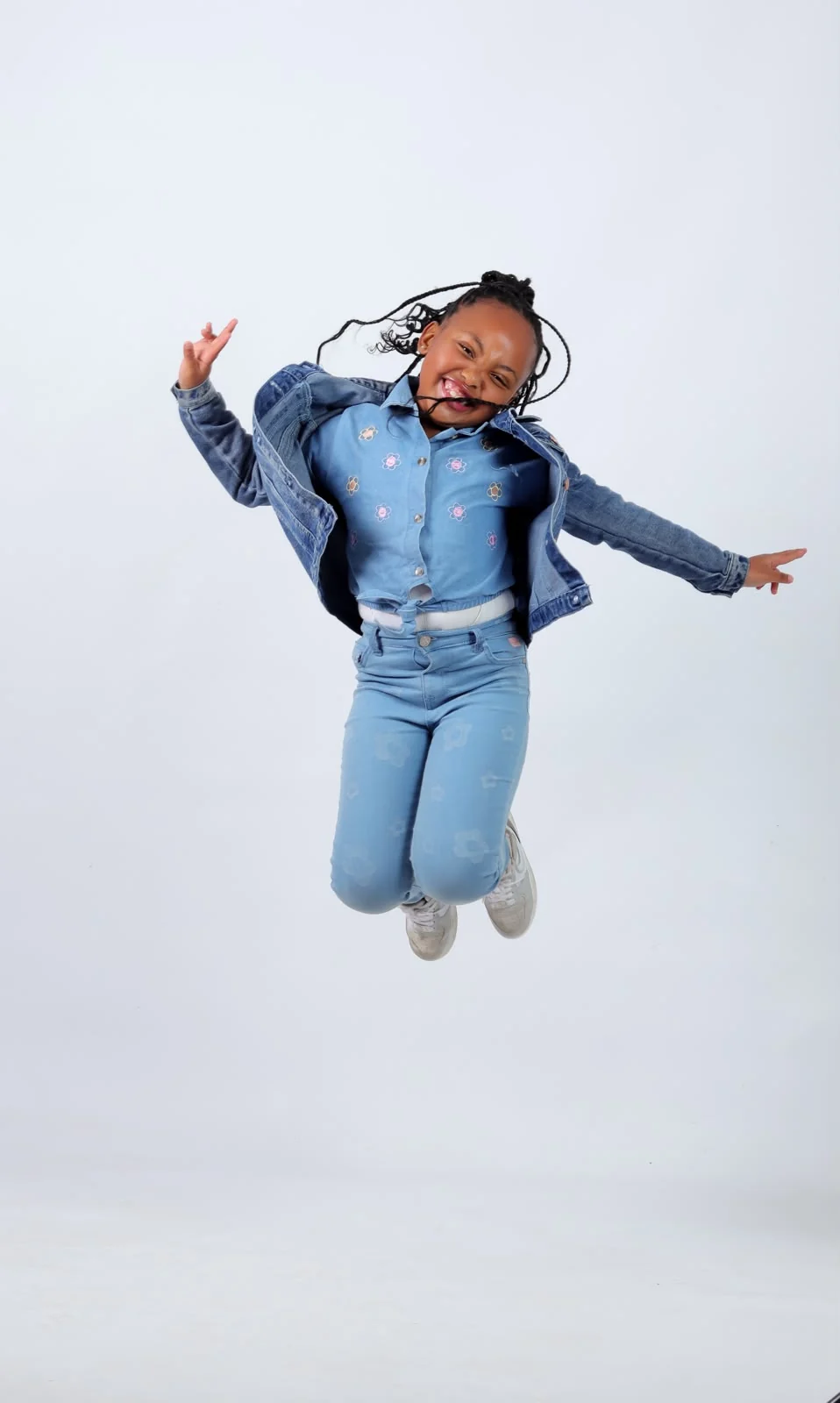 A young performer mid-jump during a portfolio shoot